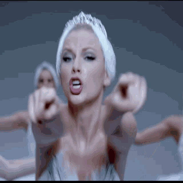 a woman in a swan costume is pointing her finger