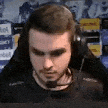 a close up of a man wearing headphones and a microphone .