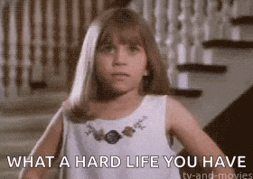 a little girl is standing in front of a staircase and says what a hard life you have
