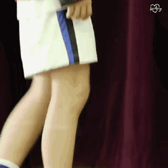a person 's legs are shown in a blurry photo with a heart in the upper right corner