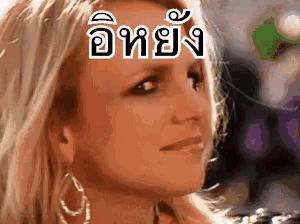 a close up of a woman 's face with foreign writing on her face .