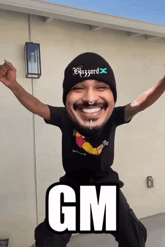 a man wearing a gm shirt and a wizard hat