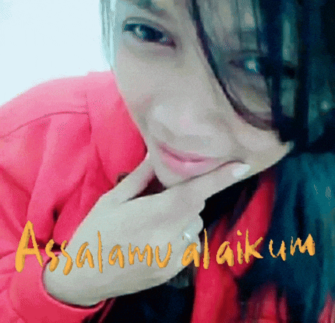 a woman in a red jacket is smiling with the word assalamu alaikum written on the bottom
