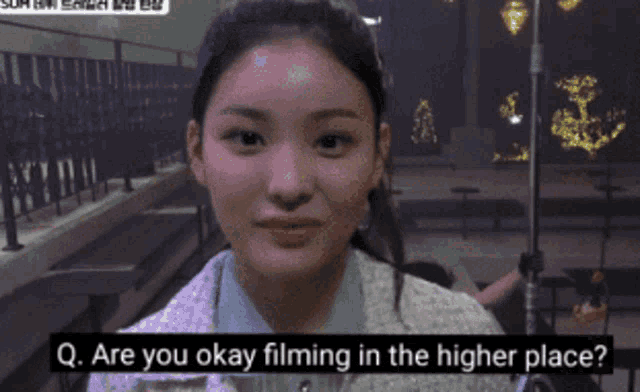 a girl is asking if she is okay filming in a higher place