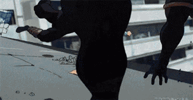 a silhouette of a person standing on a ledge with their hands outstretched