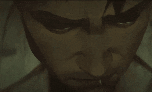 a close up of a man 's face with a serious look on his eyes .