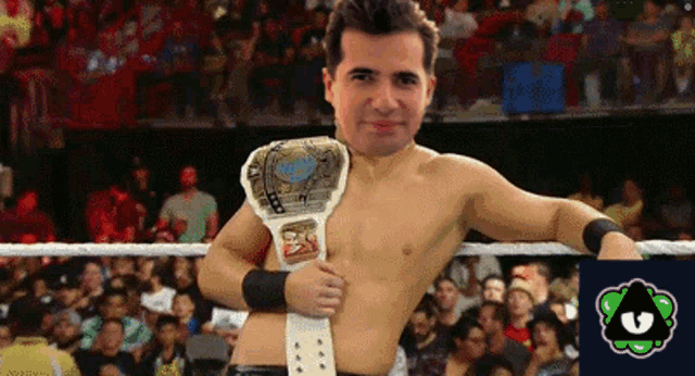 a man in a wrestling ring with a championship belt