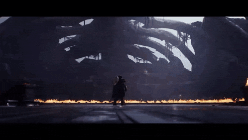 a giant monster is surrounded by fire and smoke