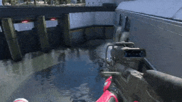 a person is holding a gun in front of a river .