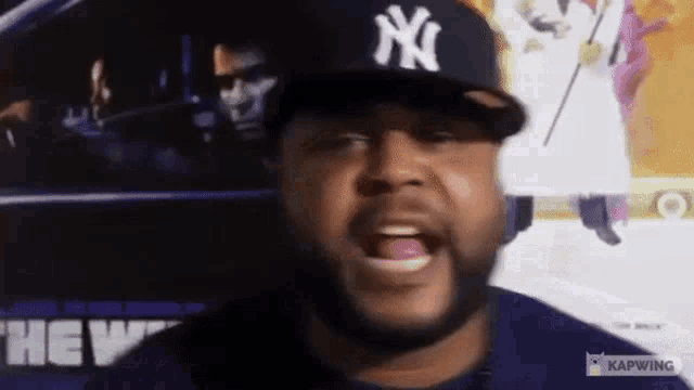 a man wearing a new york yankees hat is talking
