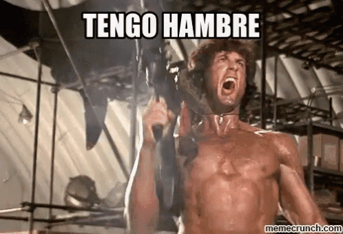 a shirtless man is holding a gun with the words `` tengo hambre '' above him .