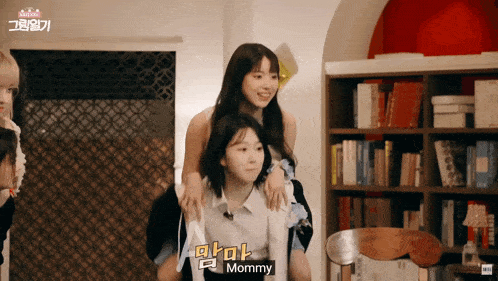 a woman carrying another woman on her shoulders with the word mommy written on the bottom