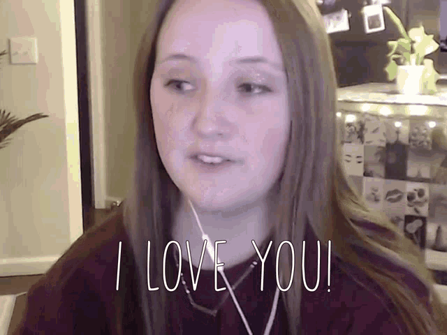 a woman wearing headphones says " i love you " in white letters
