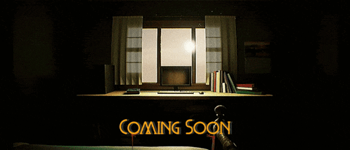 a computer monitor sits on a desk in front of a window with the words " coming soon " above it