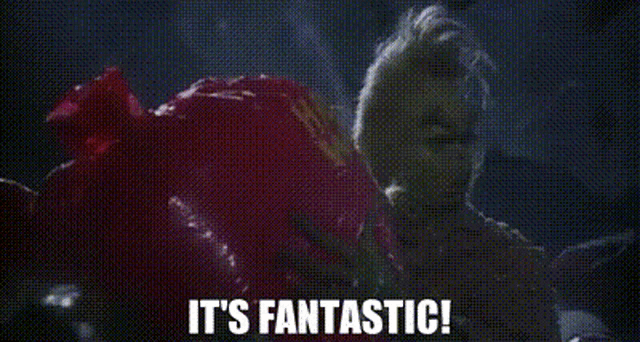 a woman in a red dress is saying `` it 's fantastic '' .