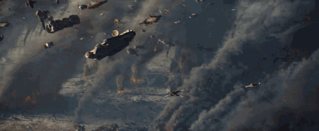 a group of fighter jets are flying through the air in a cloudy sky .