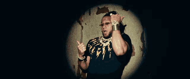 a man wearing a black shirt with a lightning bolt on it