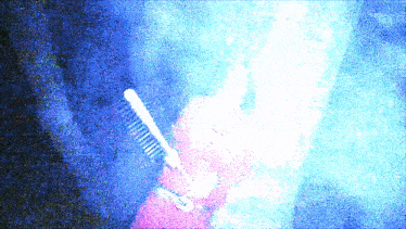 a blurry picture of a person holding a brush in their hand