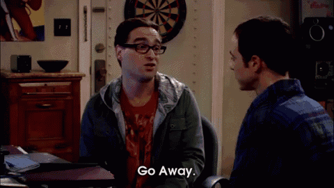 a man with glasses says go away while another man looks on