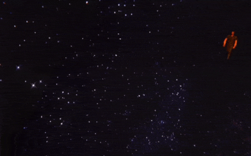 a person is standing in the middle of a dark galaxy
