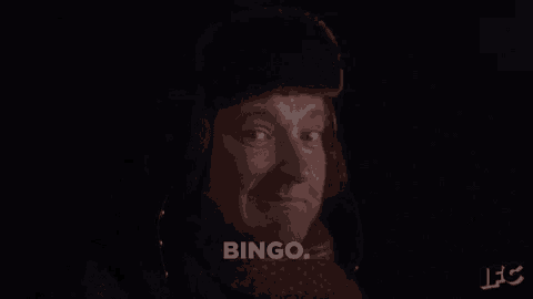 a man wearing a fur hat and scarf is talking about bingo .