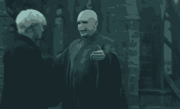 two men hugging each other in a dark room .