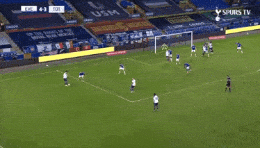 a soccer player wearing a white aia jersey is running on the field .