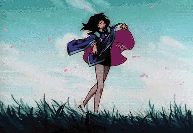 a woman in a purple cape is standing in a field