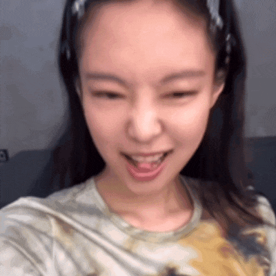 a close up of a woman taking a selfie with her mouth open and her tongue out .