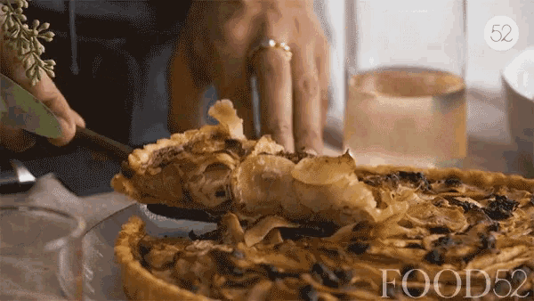 a person is taking a slice of pie from a plate that says food52 on the bottom