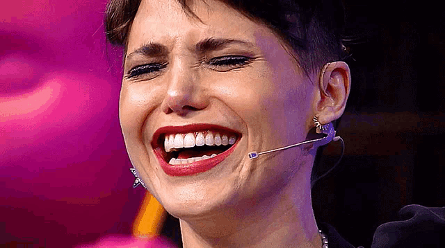 a close up of a woman 's face with a microphone in her ear