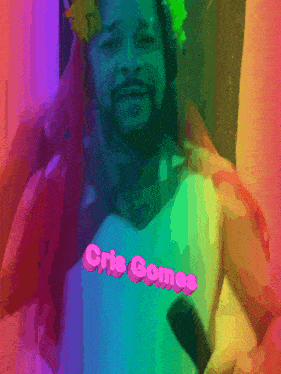 a man is holding a microphone with the name cris comes on his shirt