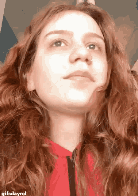a close up of a woman 's face with gifsdayrol written below it