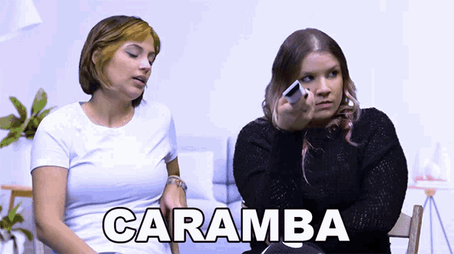 two women sitting next to each other with the word caramba on the bottom right