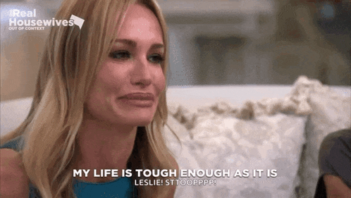 a woman is crying while sitting on a couch and saying `` my life is tough enough as it is . ''