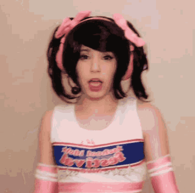 a woman in a cheerleader costume is making a funny face
