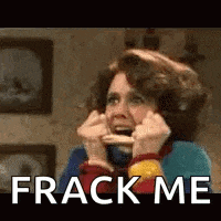 a woman is holding a piece of food in her mouth while talking on a phone .