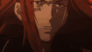 a close up of a man 's face with long red hair