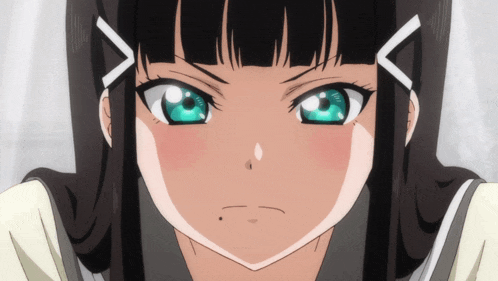 a close up of a girl 's face with black hair and green eyes