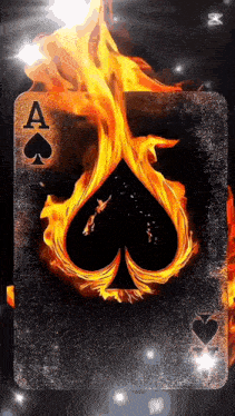 an ace of spades playing card is on fire on a black background .