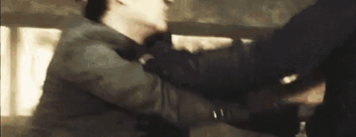 a man is holding another man 's neck in a blurred image .