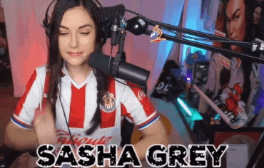 a woman wearing headphones and a shirt that says sasha grey on it