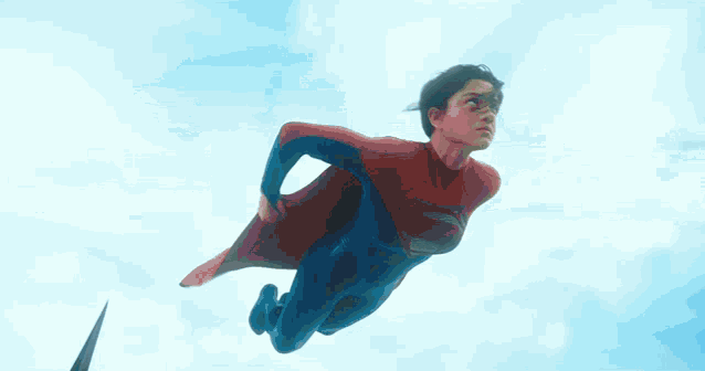superman is flying through the air with his cape spread