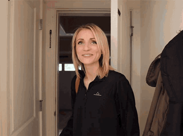 a woman wearing a black jacket that says o'neill on the front