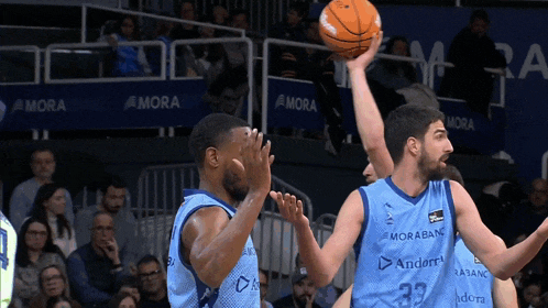 a basketball player wearing number 33 tries to block another player