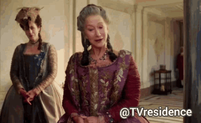 a woman in a purple dress is standing next to another woman in a blue dress and the caption says @tvresidence