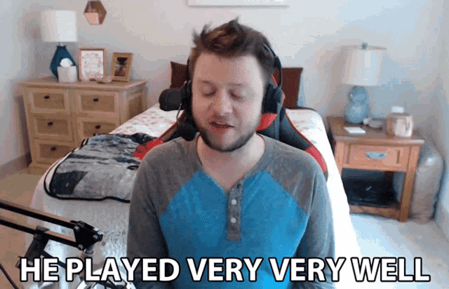 a man wearing headphones and a blue shirt says he played very well