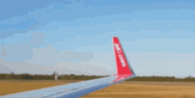 a red wing of a plane that says easyjet on it