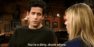 a man and a woman are talking to each other in a bar .