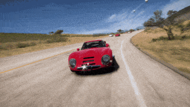 a red car is driving down a road with a license plate that says ' a ' on it